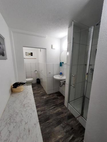 a bathroom with a shower and a toilet and a sink at Gästehaus Parkblick in Rust