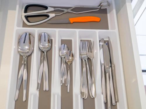 a drawer filled with silver utensils and scissors at Anchor's Haven Hersham in Groot Brak Rivier