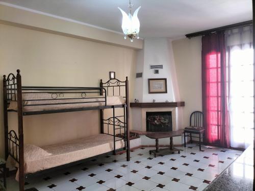 a room with two bunk beds and a fireplace at Home Vivaldi in Castellammare del Golfo