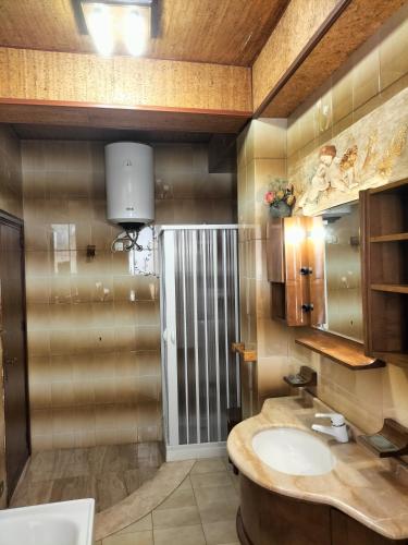a bathroom with a sink and a mirror at Home Vivaldi in Castellammare del Golfo