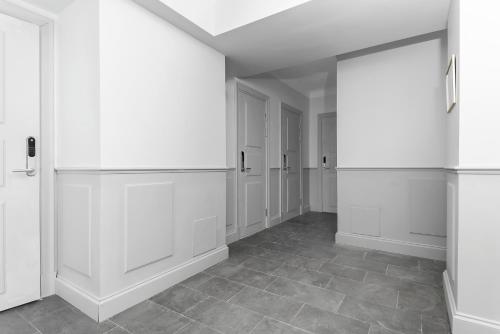 a hallway with white cabinets and a tile floor at Hotell Skeppsbron in Stockholm