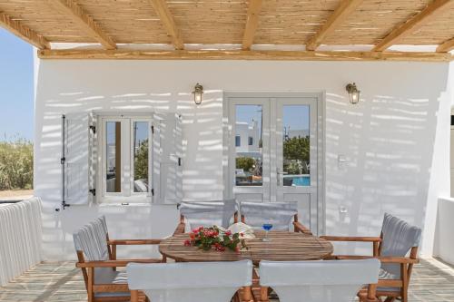 a dining room with a table and chairs at Naxian Queen Luxury Villas & Suites in Agia Anna Naxos