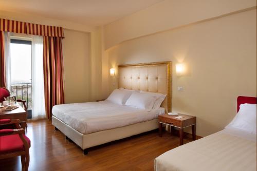 Postel nebo postele na pokoji v ubytování Giotto Hotel & Spa