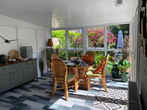 a kitchen with a table and chairs in a room at The Peels B&B in Lowestoft