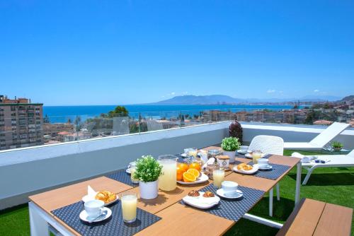 a breakfast table on a balcony with a view at Genteel Home Elcano Terrace in Málaga