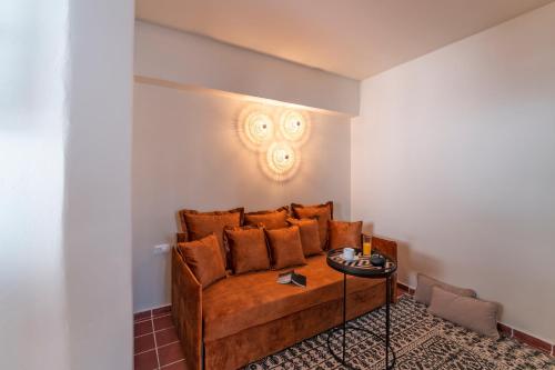 a living room with a couch and a table at Maris Lindos Suites & Apartments in Líndos