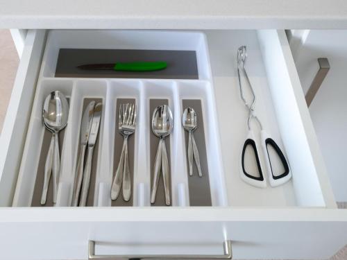 a white drawer with silver utensils in it at Anchor's Haven Hersham in Groot Brak Rivier