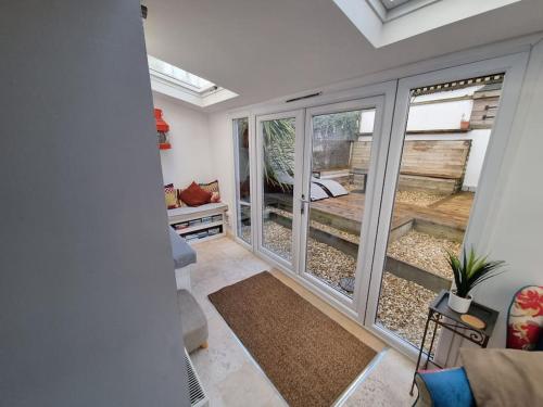 a room with sliding glass doors with a bedroom at Unique 4bed large central Hayle cottage nr St Ives in Hayle