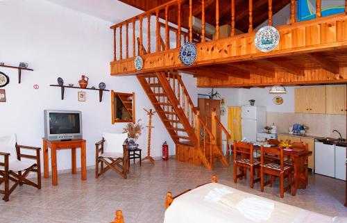 a living room with a staircase and a kitchen at Symi Blue Port Apartment in Symi