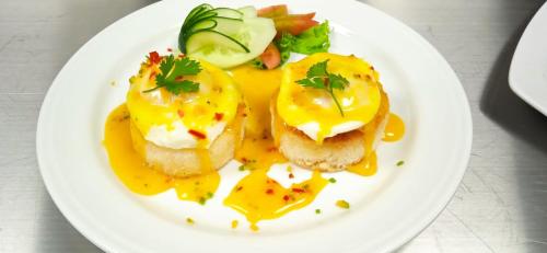 a plate of food with eggs and bread on a table at Grand Sylhet Hotel & Resort in Sylhet