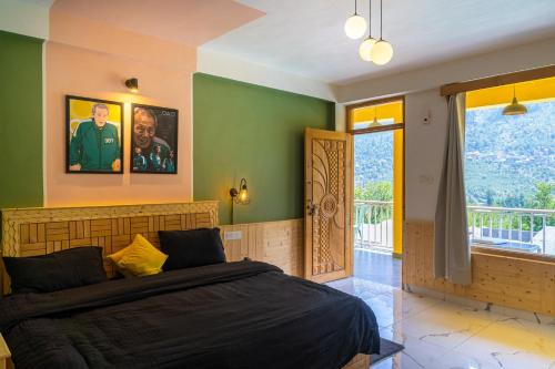 a bedroom with a large bed and a balcony at Whoopers Hostel Manali in Manāli