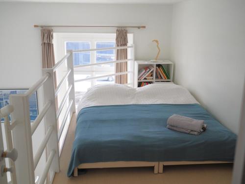 a bed in a room with a window at Le Bigorneau , beach at 20m and free private carpark in Saint Malo