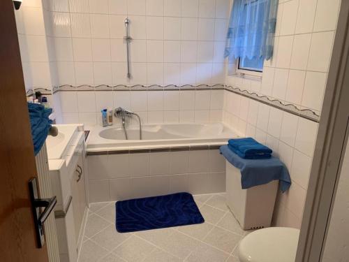 a bathroom with a tub and a toilet and a sink at apartman Luník in Svratka