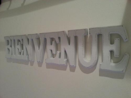 a sign that says happy birthday hanging on a wall at La Loge Du Vieux Lyon in Lyon