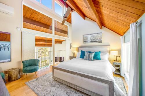 a bedroom with a bed in a room with wooden ceilings at Timber Top Retreat in Lake Arrowhead