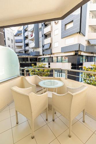 a balcony with a table and chairs on a building at Jordan`s Hotel in Vlorë