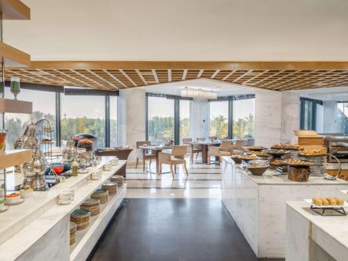 a large kitchen with a lot of food on display at The Venue Jeddah Corniche in Jeddah