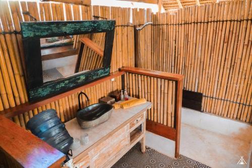 a bathroom with a mirror and a sink in a room at La Cocoteraie Ecolodge - Luxury Glamping Tents in Gili Trawangan
