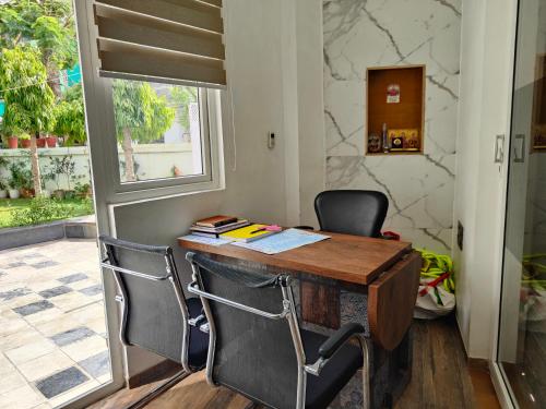 an office with a wooden desk and two chairs at House No 87A in Jaipur