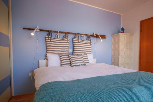 a bedroom with a large bed with striped pillows at Apartma Srčanka in Koper