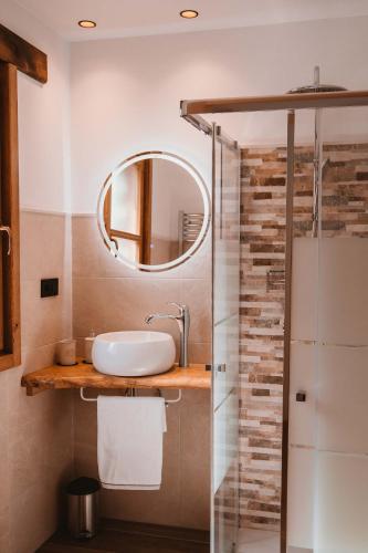 a bathroom with a sink and a mirror at El Riveru - Astur Casas Rurales in Balmori