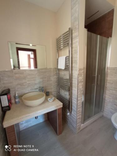 a bathroom with a large sink and a shower at La sinfonia di.kerkent in Agrigento