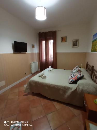 a bedroom with a bed and a flat screen tv at La sinfonia di.kerkent in Agrigento