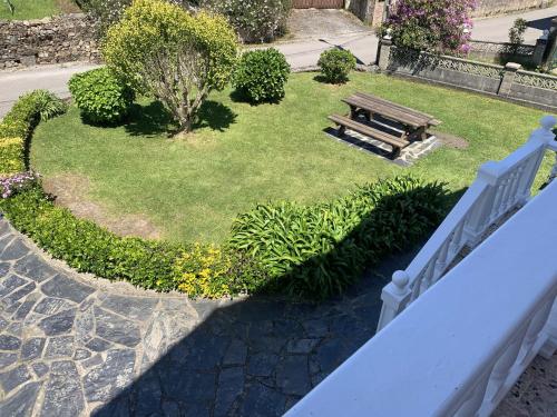a park with a bench in the grass at Apartamentos Casa Carin in Cadavedo