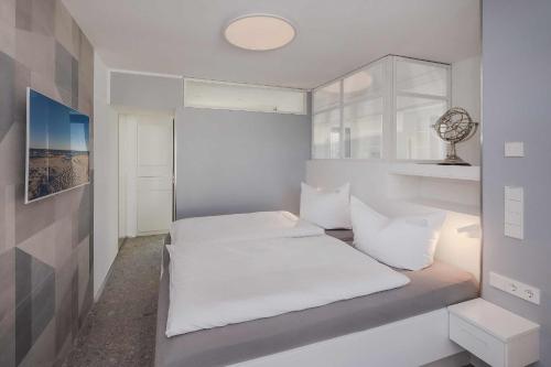 a bedroom with two beds with white sheets at Stormy in Lubmin