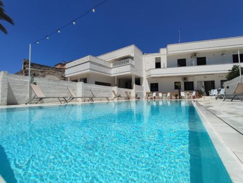 a large swimming pool in front of a building at La Gemma del Salento Rooms&Apartments in Racale