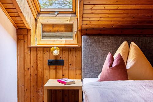 a bedroom with a bed with a window and a table at Haus Lohengrin Ferienwohnung 4 in Siusi