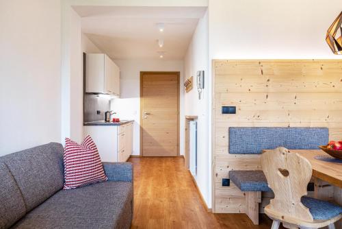 a living room with a couch and a table at Haus Lohengrin Ferienwohnung 4 in Siusi