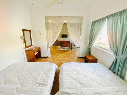 a bedroom with a bed and a living room at RumahChantiqq at Ehsan waterpark, Port Dickson in Port Dickson