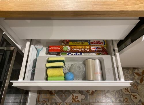 a refrigerator with some food and other items in it at Casa Stella Salento - grazioso appartamento con 2 camere da letto nel cuore di Galatone in Galatone