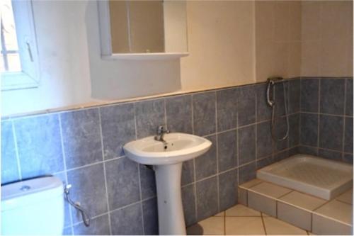a bathroom with a sink and a bath tub at SNI-Village Ambohidratrimo au bord du Lac Andranotapahana in Ambohidratrimo