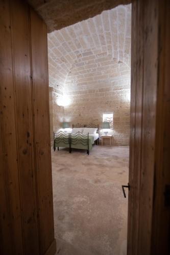 Ένα ή περισσότερα κρεβάτια σε δωμάτιο στο MASSERIA LILEI