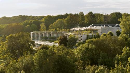 a large building with a bridge over it at Royal Champagne Hotel & Spa in Champillon