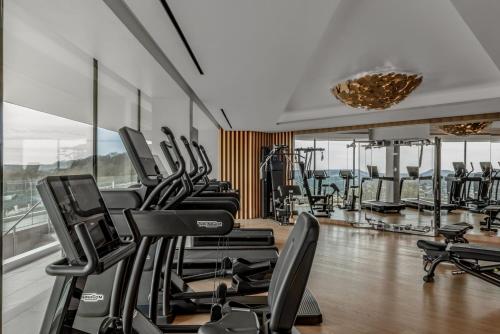a gym with a bunch of exercise bikes in a room at Royal Champagne Hotel & Spa in Champillon