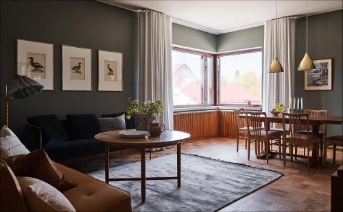 a living room with a couch and a table at Hotelli Vihannonkulma in Loimaa