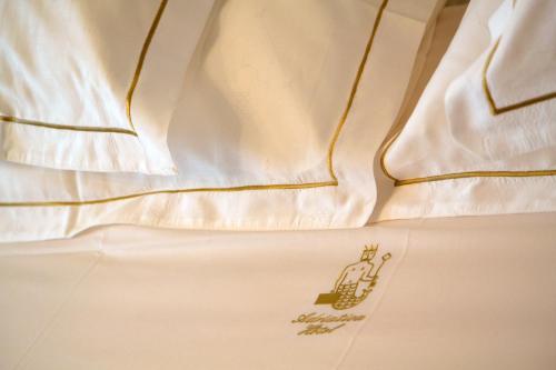 a close up of a white dress with a logo on it at Hotel Adriatica in Geneva