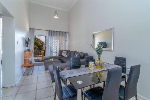 a living room with a couch and a table at Cozy All-in-One Ocean View Apartment in Kingsburgh