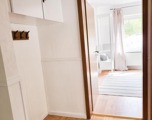 a door leading into a room with a mirror at Gästehaus an der Moseltherme in Traben-Trarbach