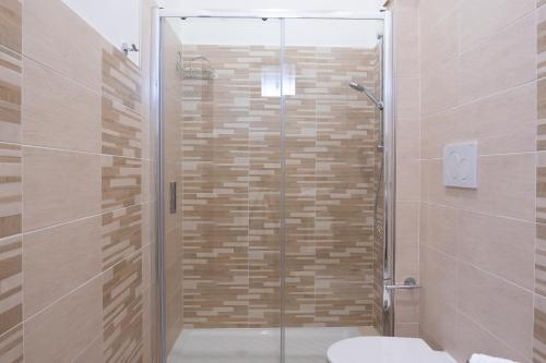 a shower with a glass door in a bathroom at Stella Marina - Camere e Monolocali Turistici in Monte San Biagio