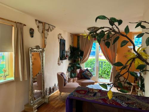 uma sala de estar com um espelho e uma mesa em La Cabaña em Zandvoort
