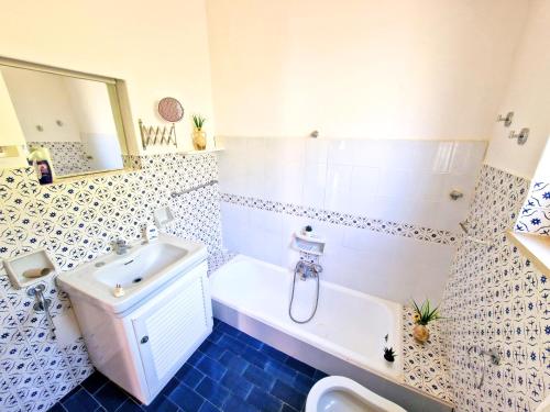 a bathroom with a sink and a tub and a toilet at Luna Caprese Room in Anacapri