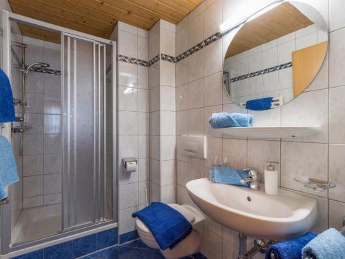 a bathroom with a sink and a shower and a mirror at Freihof in Westendorf