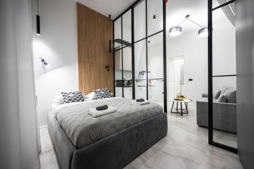 a bedroom with a large bed and a bathroom at Old Town Design Apartments in Sarajevo