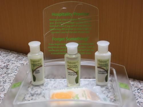 three bottles of moisturizers sitting on a tray on a counter at Holiday Inn Express & Suites Glendive by IHG in Glendive