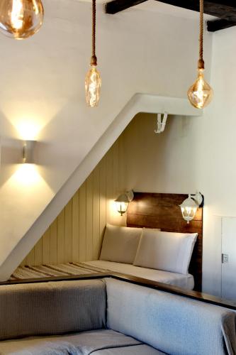 a bed in a room with lights on the ceiling at Tiny Circe house - alloggio turistico in San Felice Circeo