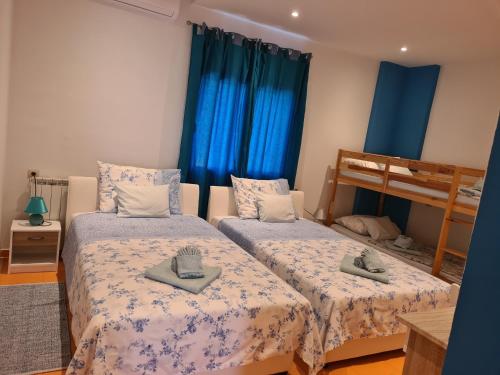 a bedroom with two beds and a bunk bed at Guest house Slatki Snovi in Knin